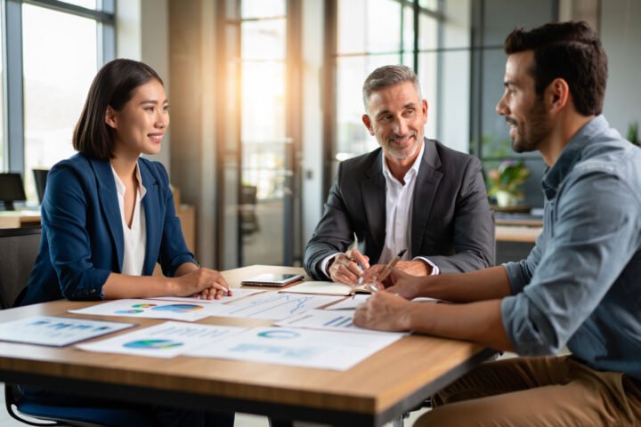 Young couple planning retirement with advisor