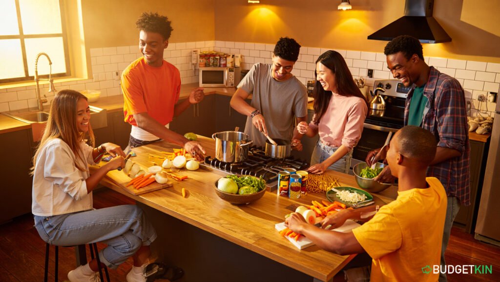7 Smart Money Rules for Students Starting University 3 Students are cooking and budgeting together to save money.