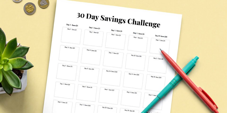 A simple printable savings tracker displayed on a desk with BudgetKin colours.