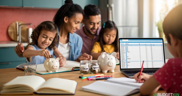 4 Powerful Family Budgeting Secrets 1 A large family sitting together at the kitchen table planning a Family Budgeting with notebooks, a laptop, and piggy-banks.