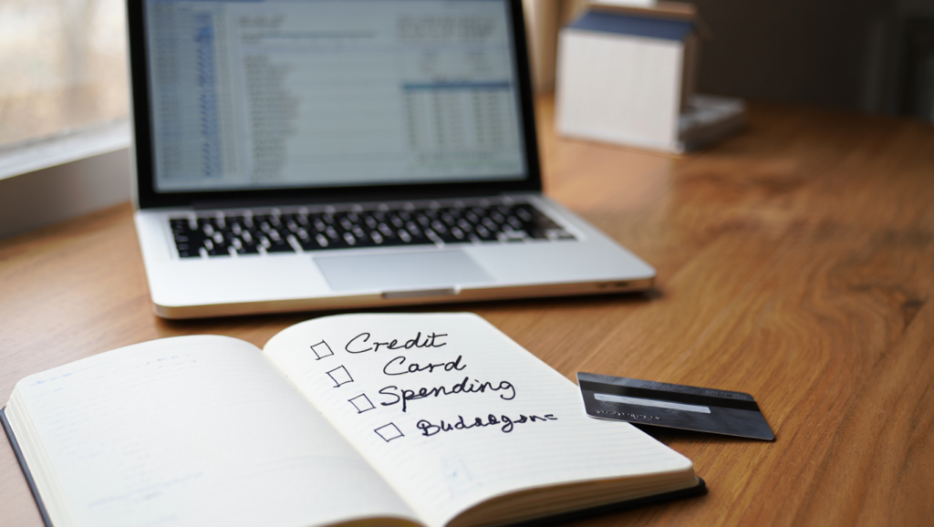 Credit card spending tracked within a household budget to avoid common credit score mistakes